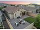 Inviting backyard with a paver patio, fire pit, lounge seating, and a patch of green grass at 20607 W Point Ridge Rd, Buckeye, AZ 85396