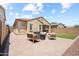 Backyard featuring desert landscaping with stone pavers and comfortable lounge seating at 20607 W Point Ridge Rd, Buckeye, AZ 85396