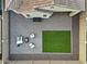 An aerial view of a backyard with a paved patio, outdoor seating, a fire pit, and green grass at 20607 W Point Ridge Rd, Buckeye, AZ 85396