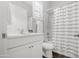 This bathroom features white cabinets, a toilet, and a shower with a curtain at 20607 W Point Ridge Rd, Buckeye, AZ 85396