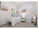 Bright bedroom with natural light, plush carpet, and a white wooden bed frame at 20607 W Point Ridge Rd, Buckeye, AZ 85396