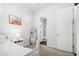 Comfortable bedroom with a white bed, side table, and ensuite bathroom at 20607 W Point Ridge Rd, Buckeye, AZ 85396