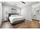 Bedroom with wood floors, tray ceiling and entry to bathroom at 20607 W Point Ridge Rd, Buckeye, AZ 85396