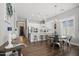 Open dining area showcasing a modern chandelier, wood floors, and seamless flow into the stylish kitchen at 20607 W Point Ridge Rd, Buckeye, AZ 85396