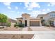 Charming single-story home featuring a circular tower entrance, desert landscaping, and a two-car garage at 20607 W Point Ridge Rd, Buckeye, AZ 85396