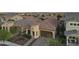 A charming home with a barrel tile roof and manicured landscaping at dusk at 20607 W Point Ridge Rd, Buckeye, AZ 85396
