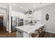 Bright kitchen featuring white cabinets, stainless steel appliances, and a spacious island with seating at 20607 W Point Ridge Rd, Buckeye, AZ 85396