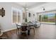 Bright living area showcasing wood flooring, large windows, and a seamless flow into the kitchen space at 20607 W Point Ridge Rd, Buckeye, AZ 85396