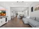 Open-concept living room with wood flooring and a comfortable sectional sofa, showcasing the bright, airy design at 20607 W Point Ridge Rd, Buckeye, AZ 85396
