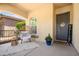 Inviting front porch with comfortable seating, decorative plants, and a welcoming entrance with a 'Welcome' sign at 20607 W Point Ridge Rd, Buckeye, AZ 85396