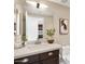 Updated bathroom with a modern sink, dark wood cabinets, and decorative plants at 2315 N 52Nd St # 102, Phoenix, AZ 85008