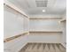 Spacious walk-in closet with carpeted floors and wooden bars for optimal storage at 2315 N 52Nd St # 102, Phoenix, AZ 85008