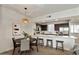 Charming dining area with a round table, unique light fixture, and convenient access to the adjacent kitchen at 2315 N 52Nd St # 102, Phoenix, AZ 85008