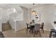 Bright dining area with modern light fixture adjacent to a staircase and a kitchen with a breakfast bar at 2315 N 52Nd St # 102, Phoenix, AZ 85008
