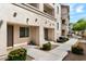 Attractive condo complex featuring a well-maintained walkway and desert landscaping under a clear, blue sky at 2315 N 52Nd St # 102, Phoenix, AZ 85008