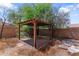 Tranquil backyard featuring a charming pergola with a brick pathway, surrounded by lush greenery and trees at 23955 W La Salle St, Buckeye, AZ 85326