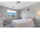 Cozy bedroom featuring a window with natural light, a soft pink bedspread and playful decorations at 23955 W La Salle St, Buckeye, AZ 85326
