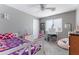 Bright bedroom with a ceiling fan, colorful decor, and a comfortable beanbag chair at 23955 W La Salle St, Buckeye, AZ 85326