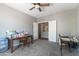 Cozy bedroom features neutral walls, carpet flooring, a desk, and a ceiling fan at 23955 W La Salle St, Buckeye, AZ 85326