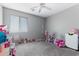 Spacious bedroom with a large window, playful toys, and ample space for activities at 23955 W La Salle St, Buckeye, AZ 85326