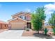 Charming two-story home with a well-manicured lawn, a two-car garage, and desert landscaping at 23955 W La Salle St, Buckeye, AZ 85326