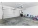 Clean and open garage space with room for parking and storage, featuring a garage door and ample lighting at 23955 W La Salle St, Buckeye, AZ 85326
