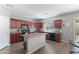 Well-appointed kitchen features granite countertops, modern appliances, and wood-look floors at 23955 W La Salle St, Buckeye, AZ 85326