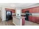 Bright kitchen featuring an island, updated appliances, and wood-look floors at 23955 W La Salle St, Buckeye, AZ 85326