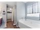 Relaxing main bathroom features a soaking tub and leads to a generous walk-in closet at 23955 W La Salle St, Buckeye, AZ 85326