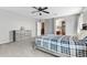 Comfortable main bedroom features neutral tones, soft carpet, ceiling fan, and en suite bathroom at 23955 W La Salle St, Buckeye, AZ 85326