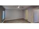 This bedroom boasts wood-look floors, a ceiling fan, neutral paint, and ample natural light at 2400 E Baseline Ave # 144, Apache Junction, AZ 85119