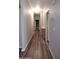 Bright hallway with wood-look floors and neutral paint leads to other rooms at 2400 E Baseline Ave # 144, Apache Junction, AZ 85119