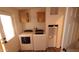 Well-lit laundry room features modern washer and dryer units with storage above at 2400 E Baseline Ave # 144, Apache Junction, AZ 85119