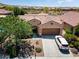 Aerial view of home featuring desert landscaping, driveway, tile roof, and community at 26725 W Marco Polo Rd, Buckeye, AZ 85396
