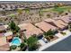 An aerial view of homes in a community near a golf course and desert landscape at 26725 W Marco Polo Rd, Buckeye, AZ 85396