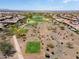An aerial view showcases a desert community with a golf course at 26725 W Marco Polo Rd, Buckeye, AZ 85396