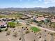 Scenic aerial view showcases homes in a desert community near golf course at 26725 W Marco Polo Rd, Buckeye, AZ 85396