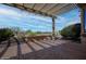 Enjoy the desert views from this shaded patio, complete with comfortable seating and serene landscape at 26725 W Marco Polo Rd, Buckeye, AZ 85396