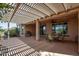 Inviting outdoor space featuring a covered patio, grill, and dining area with desert views at 26725 W Marco Polo Rd, Buckeye, AZ 85396