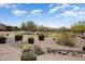 Beautiful backyard area overlooking the community golf course with desert landscaping features at 26725 W Marco Polo Rd, Buckeye, AZ 85396