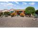 Desert landscaped backyard with covered patio and mature plantings at 26725 W Marco Polo Rd, Buckeye, AZ 85396