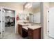 Bathroom showcases an expansive vanity area, enhanced by a large mirror, and a walk-in closet at 26725 W Marco Polo Rd, Buckeye, AZ 85396