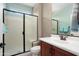 Bathroom featuring a glass enclosed shower, a vanity, and a lavatory at 26725 W Marco Polo Rd, Buckeye, AZ 85396