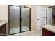 Bathroom features a sleek glass shower and a convenient door leading to the closet at 26725 W Marco Polo Rd, Buckeye, AZ 85396