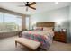 Bright bedroom with a ceiling fan, a bench seat, and a large window for ample natural light at 26725 W Marco Polo Rd, Buckeye, AZ 85396