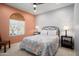 Bedroom with an arch feature, neutral walls, a ceiling fan, and two windows at 26725 W Marco Polo Rd, Buckeye, AZ 85396