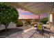 Virtually staged covered patio showcasing an idyllic evening setting, desert views, and outdoor dining at 26725 W Marco Polo Rd, Buckeye, AZ 85396
