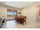 Dining room boasts tile flooring, a wooden table set and access to the outdoor patio at 26725 W Marco Polo Rd, Buckeye, AZ 85396
