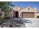 Charming home featuring a desert landscape, inviting front entrance, and two-car garage at 26725 W Marco Polo Rd, Buckeye, AZ 85396