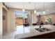 Open kitchen features granite countertops, stainless steel sink and access to the backyard at 26725 W Marco Polo Rd, Buckeye, AZ 85396